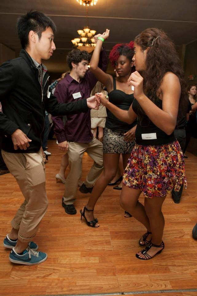 Four students dancing